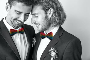 Happy Couple wearing rainbow bow ties, LGBTQ+ engagement photo